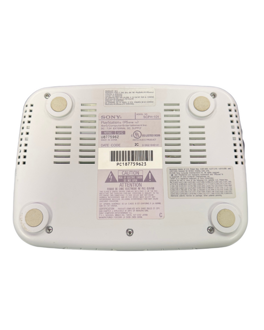 Bottom view of a Sony PSone slim console showing screw placements, vents, and label details.