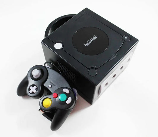 Front view of a black Nintendo GameCube console with a matching third-party controller connected to one of the front ports.