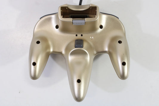 Bottom view of the gold Nintendo 64 controller, showing ergonomic contours, connector port, and structural design for stable grip during gameplay
