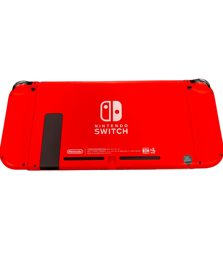 Rear view of the red Mario Edition Nintendo Switch console with matching red Joy-Con controllers attached, showing the solid red back casing and kickstand.
