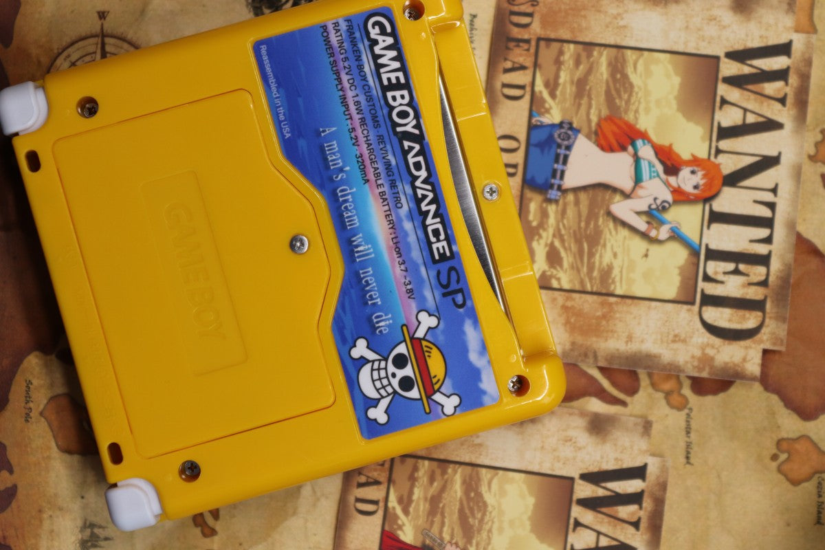 Game Boy Advance SP Custom One Piece Shell Nintendo handheld console with custom One Piece themed shell clamshell design backlit screen rechargeable battery cartridge based portable retro gaming system back