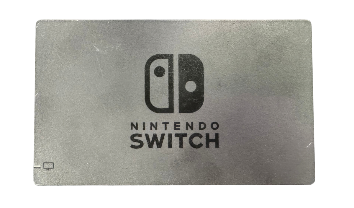 Nintendo Switch System NS with Dock Green and Purple Joy Cons Scratch and Scuff Condition Nintendo hybrid gaming console handheld and TV play modes detachable Joy Con controllers touchscreen display multiplayer gaming dock included colorful controller design used Nintendo gaming system console hardware collectible gaming setup appeal deck