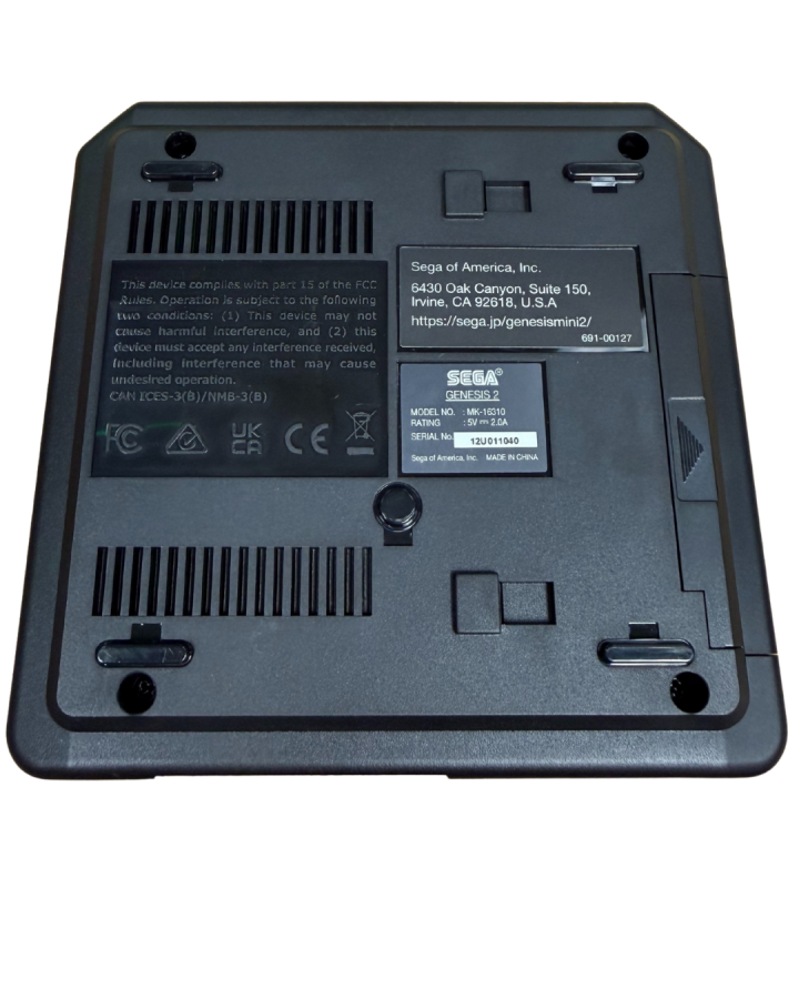 bottom view of a Sega Genesis Mini 2 console showing the top surface, controller ports, power button, and logo from a slightly angled perspective.