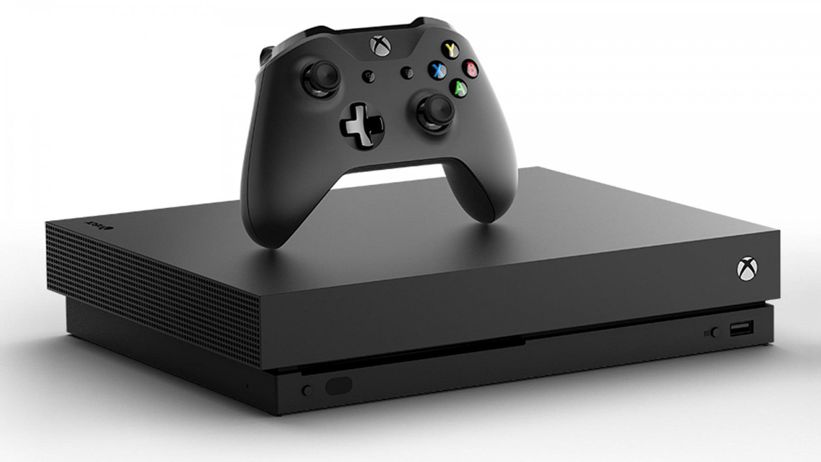Front view of a black Xbox One X gaming console with matching black wireless controller, disc drive, and textured finish