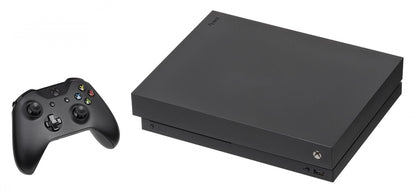 Front view of a black Xbox One X gaming console with matching black wireless controller, disc drive, and textured finish
