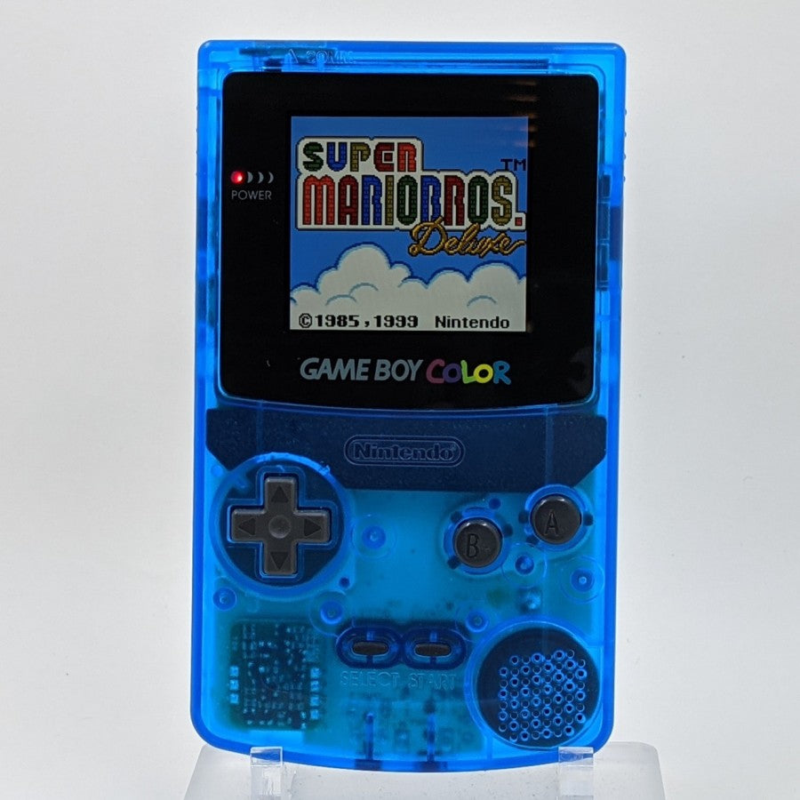 Game Boy Color GBC handheld console, custom blue clear shell, portable Nintendo system, retro gaming, scratch and scuff cosmetic condition front facing with game playing