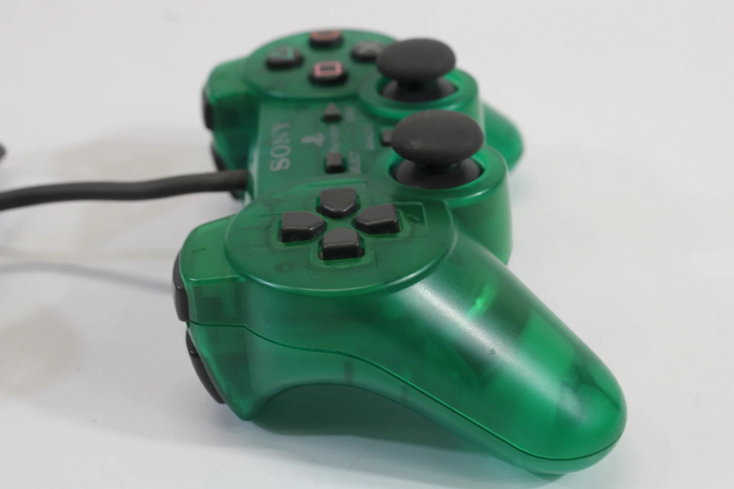 PlayStation 2 DualShock 2 controller in Clear Green official Sony accessory wired analog pressure-sensitive buttons vibration feedback PS2 console compatible left side