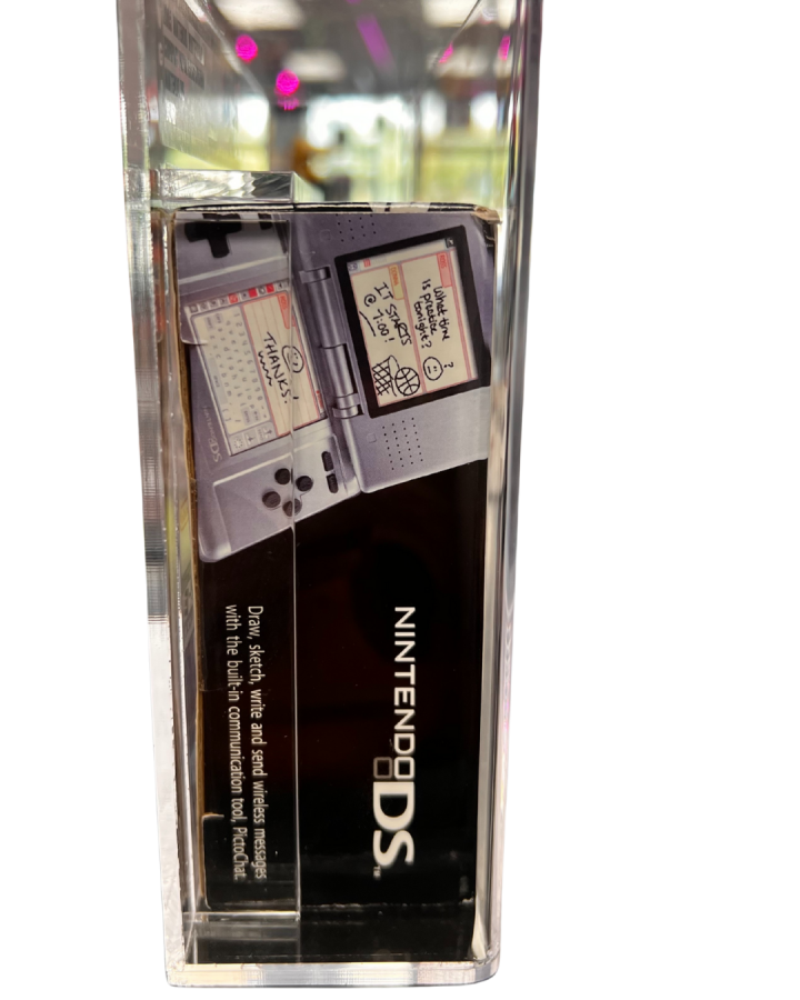 Side view of a sealed, VGA-graded Nintendo DS system encased in a clear acrylic display box with grading label attached at the top.