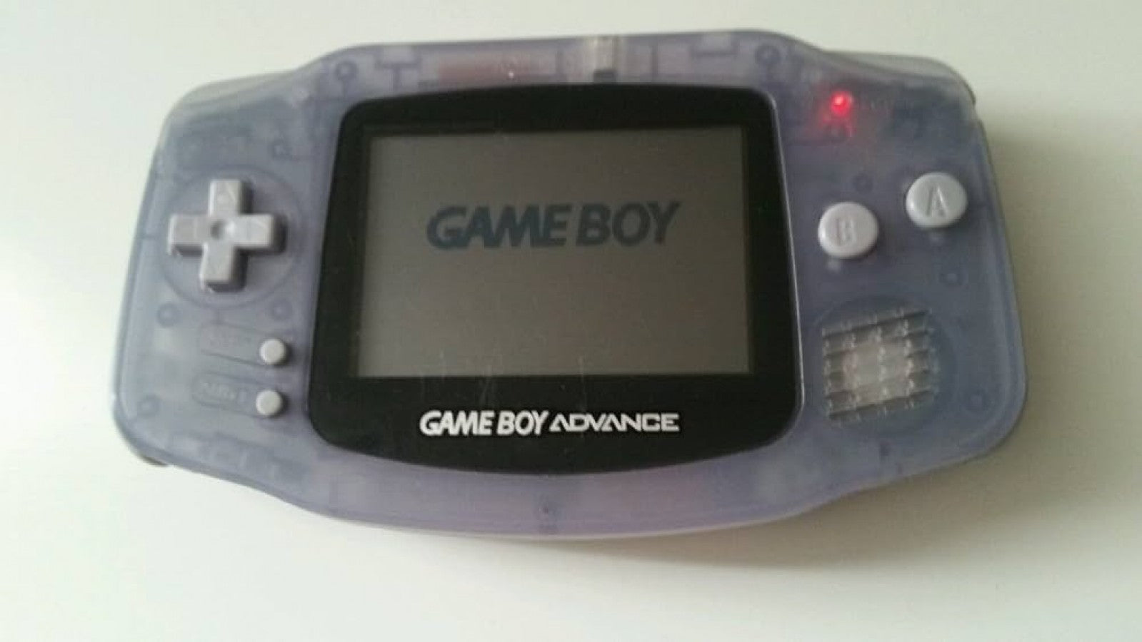 Game Boy Advance GBA handheld console Glacier color, portable Nintendo system, retro gaming device, good condition close up of turned on (not this device)