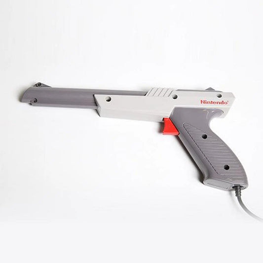 OEM Nintendo Zapper light gun accessory in gray for the Nintendo Entertainment System NES official authentic peripheral with orange tip trigger grip and cable connector for Duck Hunt and other shooting games left side