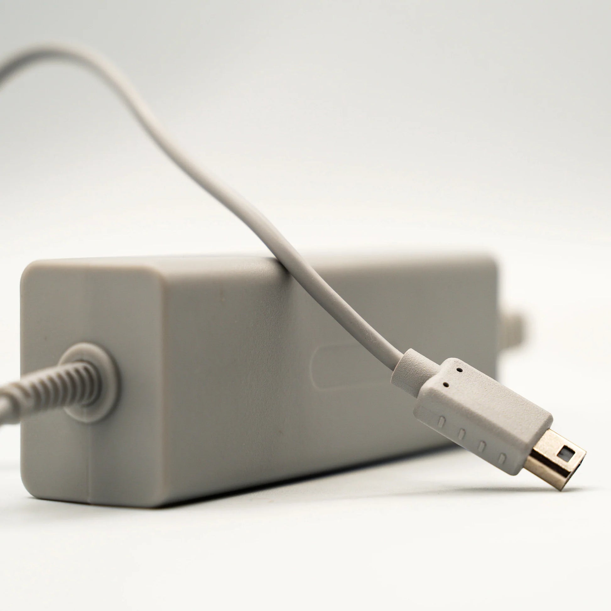Wii U GamePad AC Adapter inspired design featuring Nintendo handheld controller charging accessory aesthetic reliable power supply replacement hardware convenient charging connection essential gaming setup compatible Wii U GamePad presentation cable  