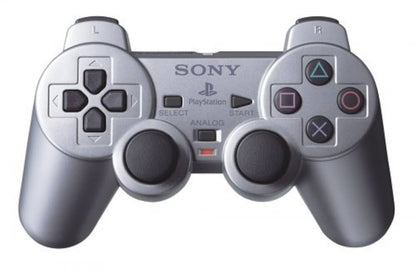 Silver PlayStation 2 DualShock 2 controller featuring analog precision, vibration feedback, and sleek metallic finish front view