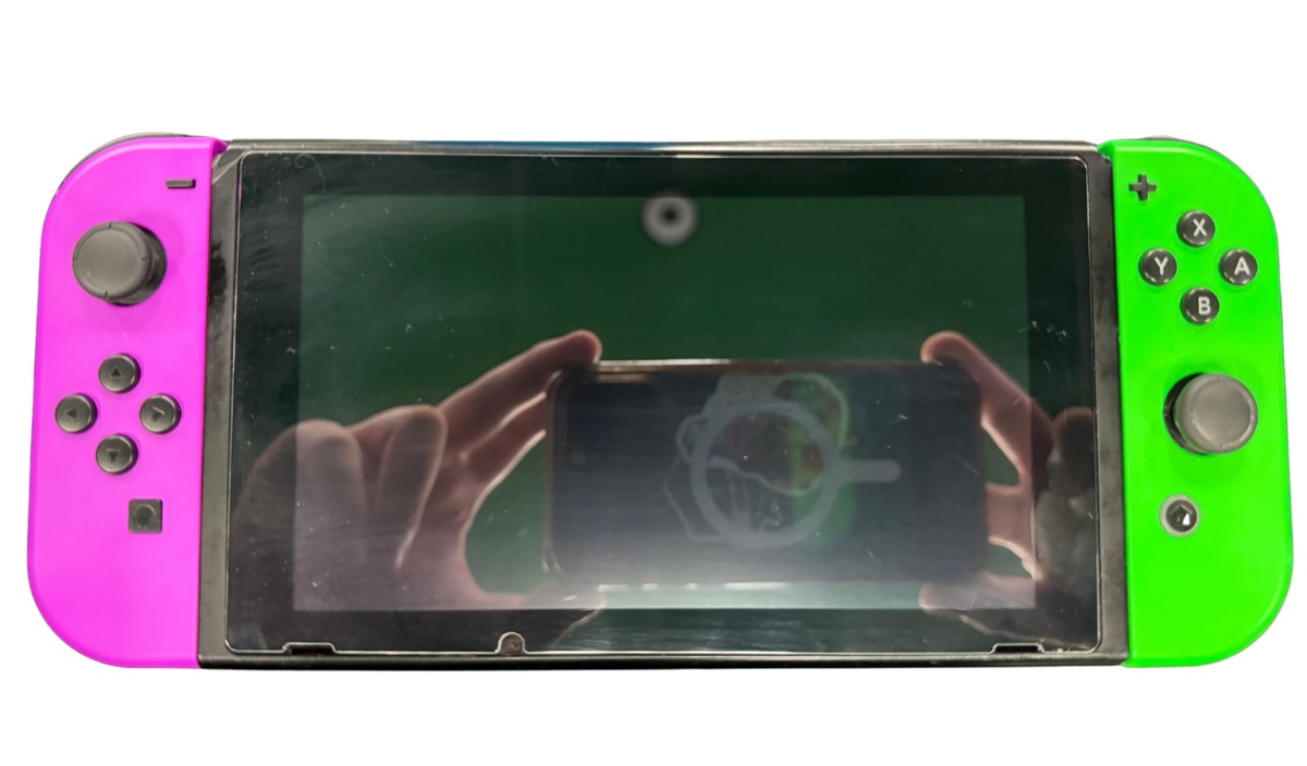 Nintendo Switch System NS with Dock Green and Purple Joy Cons Scratch and Scuff Condition Nintendo hybrid gaming console handheld and TV play modes detachable Joy Con controllers touchscreen display multiplayer gaming dock included colorful controller design used Nintendo gaming system console hardware collectible gaming setup appeal hand held