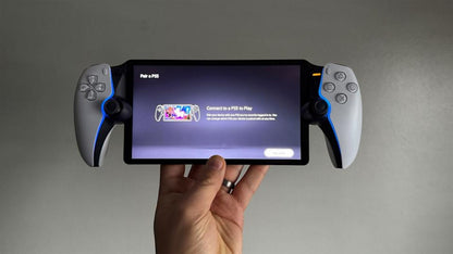 PlayStation Portal Remote Player in good condition for PS5 at Gamers INC, featuring an 8-inch Full HD screen and DualSense controller integration for seamless handheld gaming and remote play throughout your home held in hand