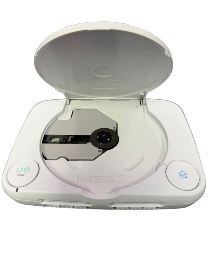 Top down view of a Sony PSone slim console with the disc lid open, showing the disc tray and laser lens area.