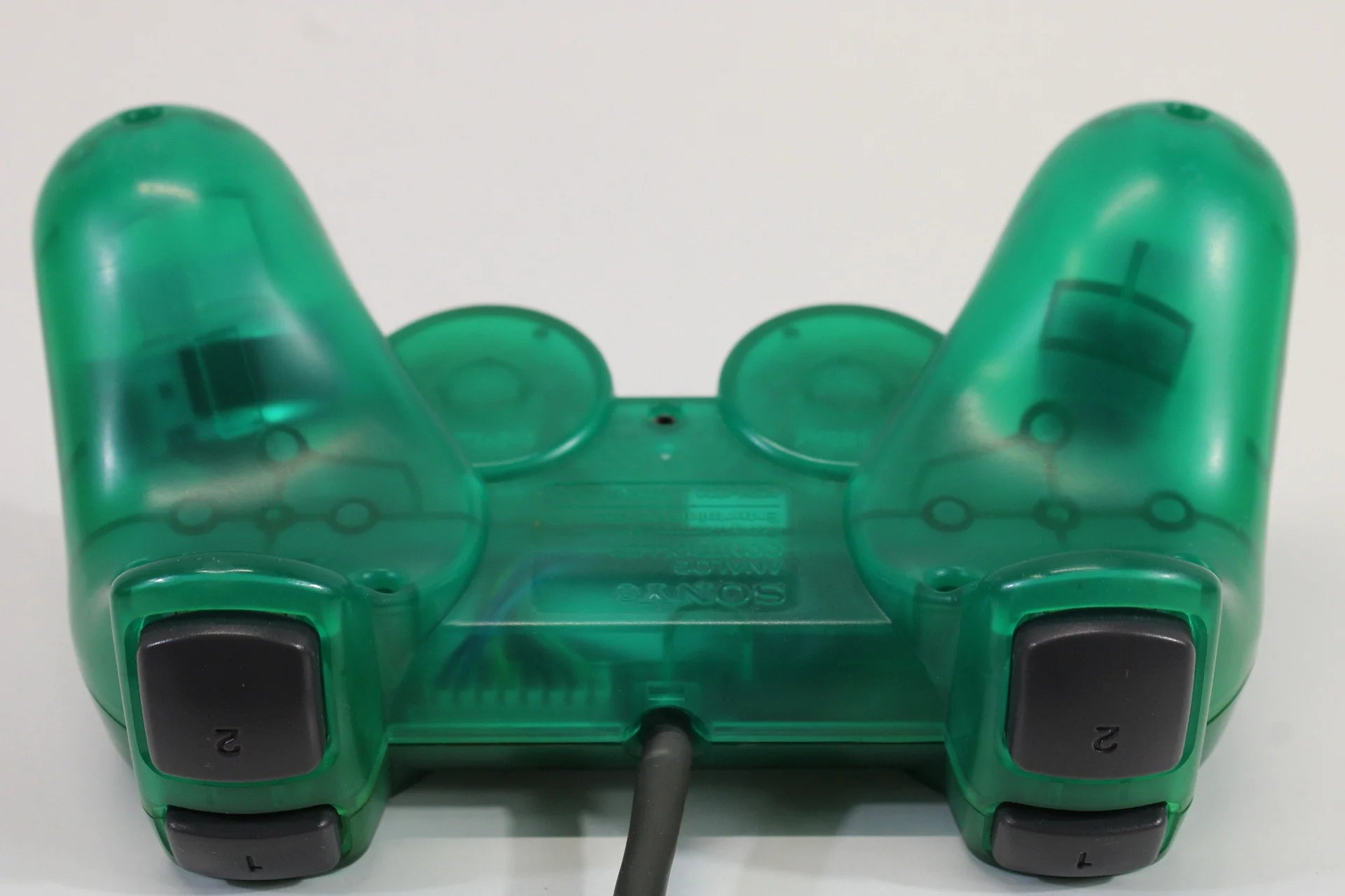 PlayStation 2 DualShock 2 controller in Clear Green official Sony accessory wired analog pressure-sensitive buttons vibration feedback PS2 console compatible top bumpers
