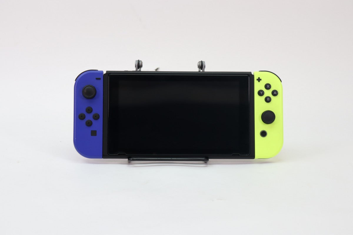 Nintendo Switch system with dock and blue and yellow Joy Cons featuring versatile home and portable gaming modes front view