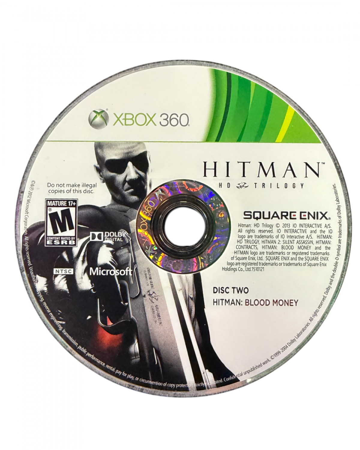 Hitman HD Trilogy Xbox 360 game featuring remastered versions of Hitman 2 Silent Assassin Hitman Contracts and Hitman Blood Money with stealth based gameplay open ended assassination missions upgraded HD visuals and the iconic Agent 47 experience disc two