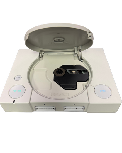 Front view of a classic Sony PlayStation 1 console with the disc lid open, showing the disc tray and laser lens area.
