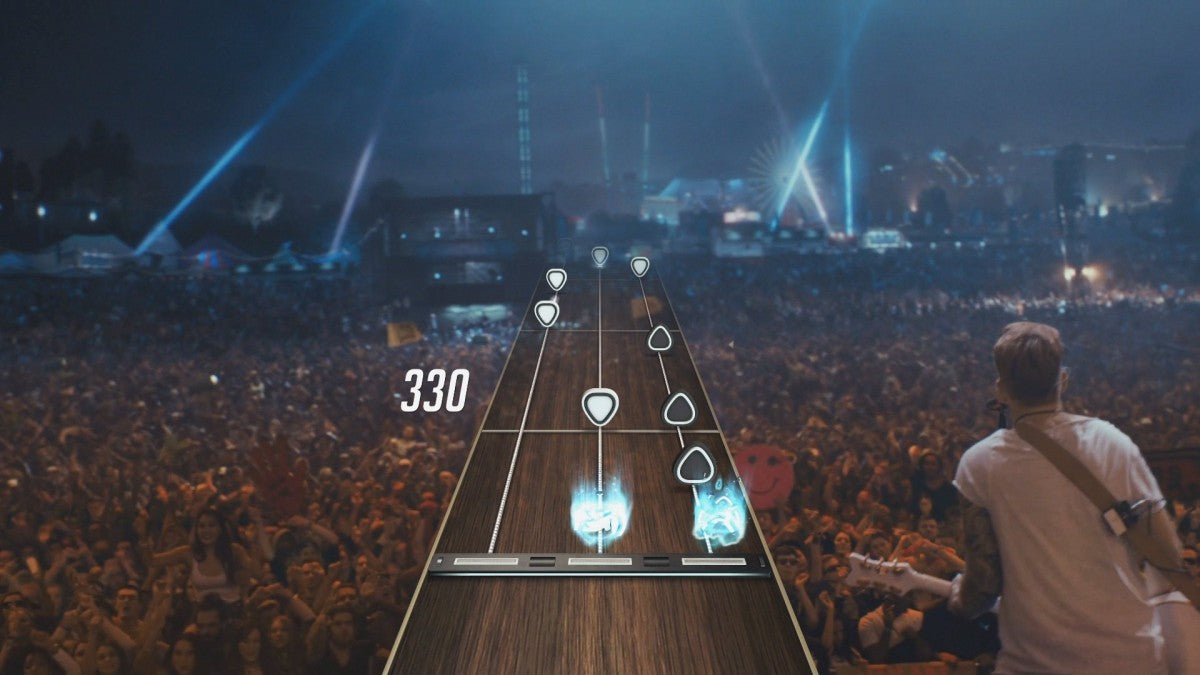 Guitar Hero Live Xbox 360 rhythm music video game franchise reboot redesigned 6-button guitar controller GH Live first-person FMV concert crowds reactive audience GHTV playable music video network streaming song library competitive leaderboards gameplay screenshot