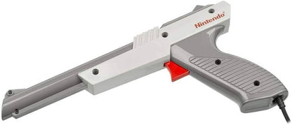 OEM Nintendo Zapper light gun accessory in gray for the Nintendo Entertainment System NES official authentic peripheral with orange tip trigger grip and cable connector for Duck Hunt and other shooting games left side aim down
