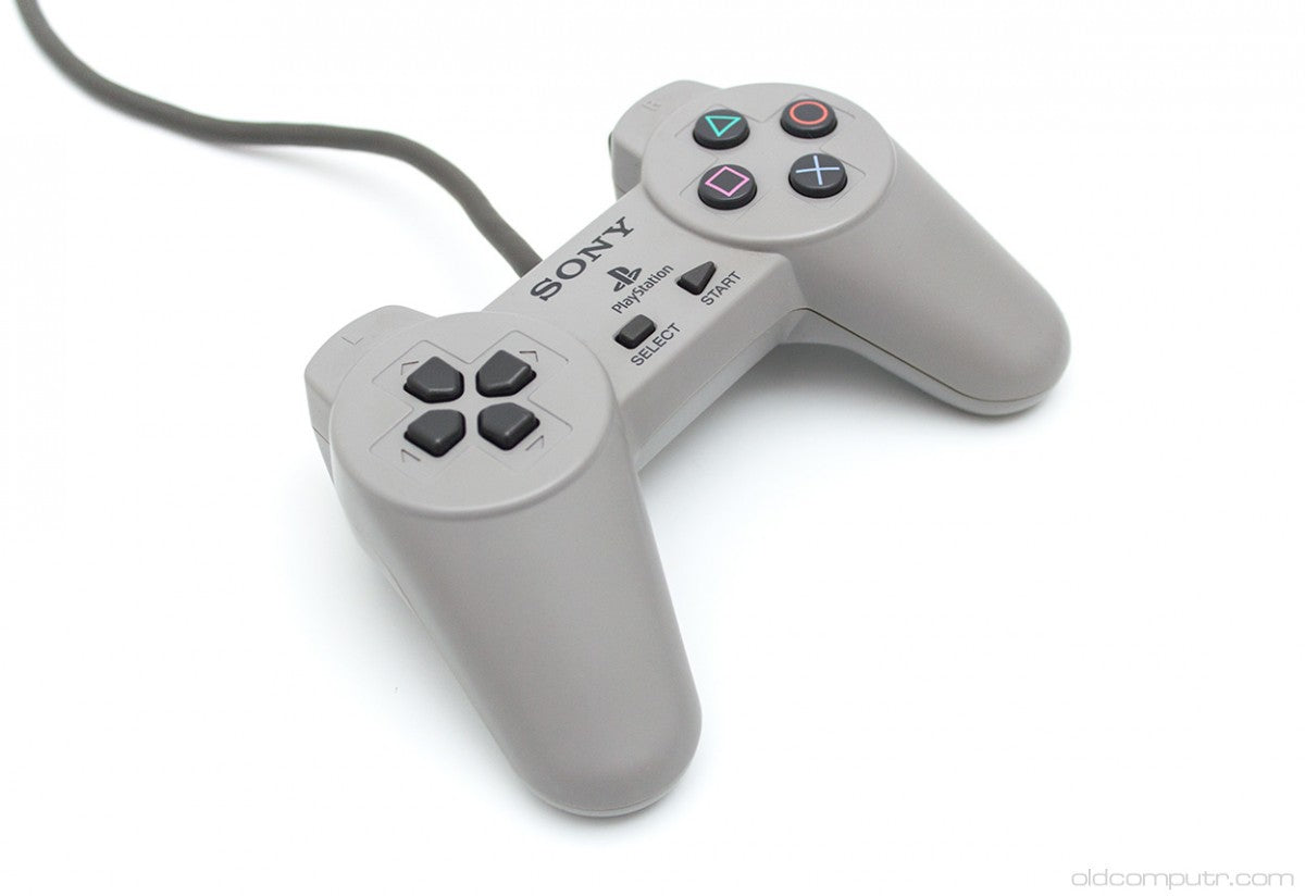 Original Sony PlayStation 1 controller with gray finish featuring directional pad, four action buttons, start and select buttons, and dual shoulder buttons