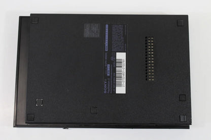 Sony PlayStation 2 Slim Console System (SCPH-90000) at Gamers INC, featuring a compact design with built-in AC adapter and PS1 backwards compatibility for playing your entire library of classic PlayStation and PS2 games with a 3rd party controller bottom side