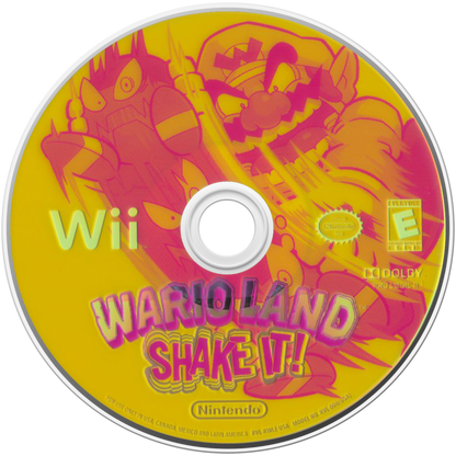 Wario Land: Shake It disc art for Nintendo Wii (Wii) featuring side‑scrolling platform action with hand‑drawn animation, treasure hunting, and motion‑controlled shaking mechanics.