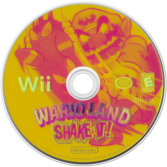 Wario Land: Shake It disc art for Nintendo Wii (Wii) featuring side‑scrolling platform action with hand‑drawn animation, treasure hunting, and motion‑controlled shaking mechanics.