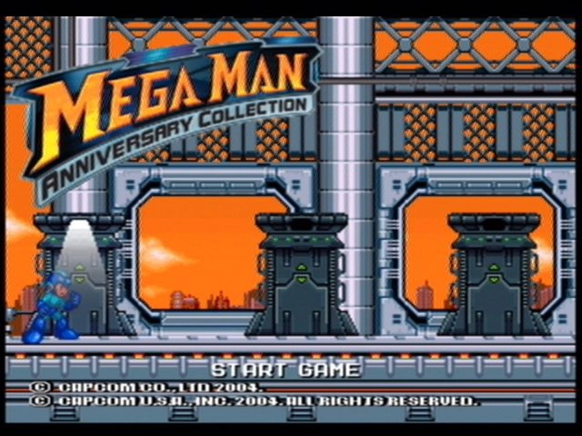 Mega Man Anniversary Collection PlayStation 2 (PS2) title screen showing classic characters and bold retro graphics.