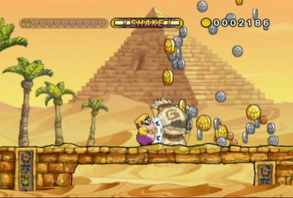 Wario Land: Shake It gameplay for Nintendo Wii (Wii) featuring side‑scrolling platform action with hand‑drawn animation, treasure hunting, and motion‑controlled shaking mechanics.