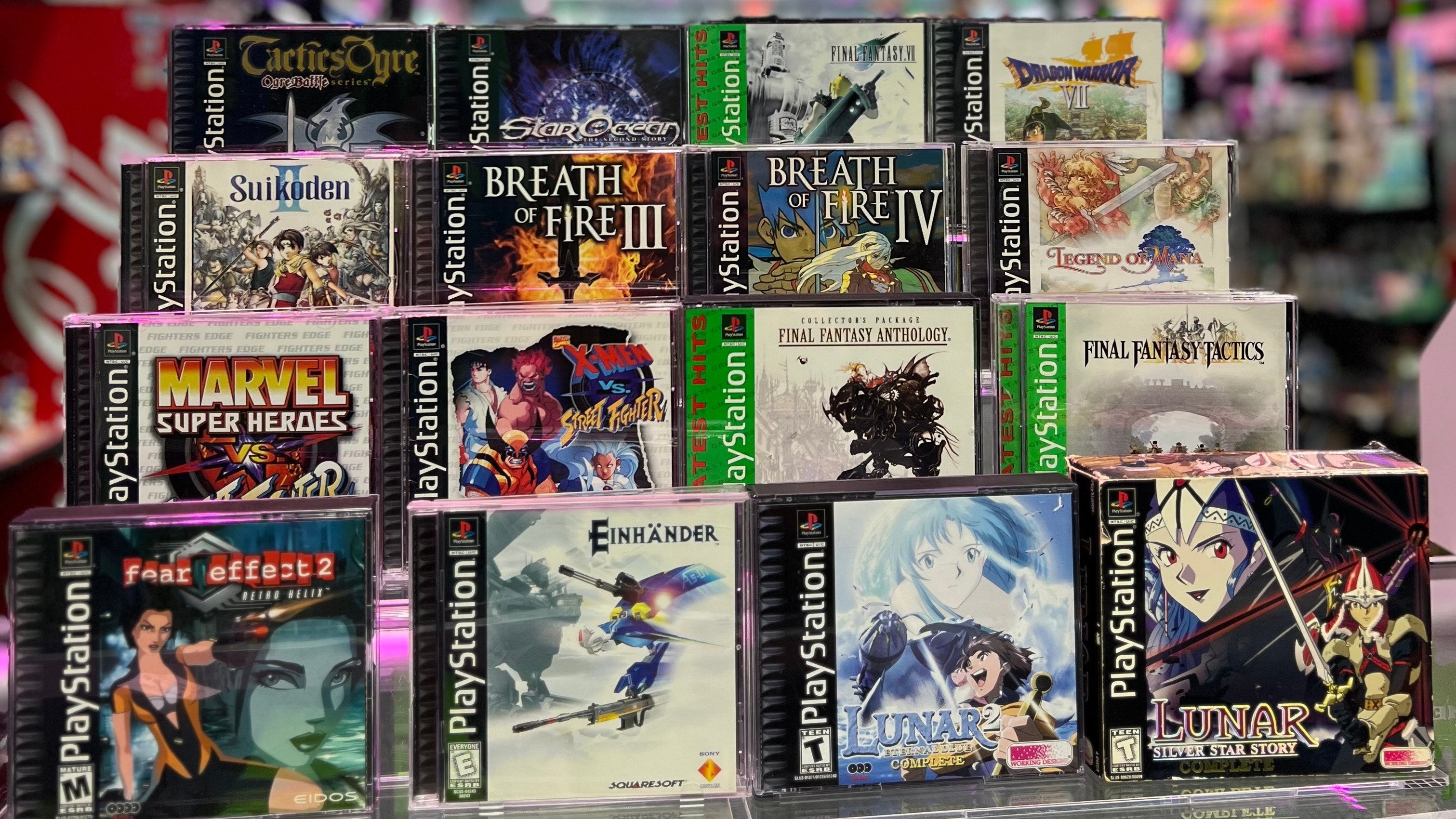 Collection of PlayStation games displayed in a store setting with colorful lighting at Gamers Inc Orlando Gamers Go Retro