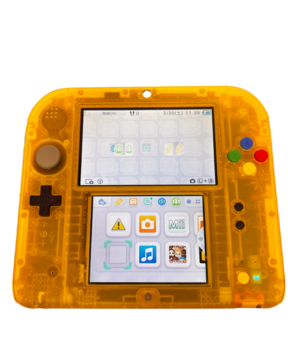 Front view of the Pokémon Yellow Edition Japanese Nintendo 2DS console powered on, displaying the home menu on its dual screens.