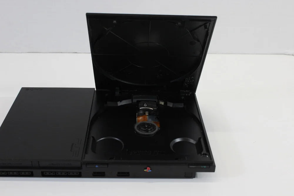 Sony PlayStation 2 Slim Console System (SCPH-90000) at Gamers INC, featuring a compact design with built-in AC adapter and PS1 backwards compatibility for playing your entire library of classic PlayStation and PS2 games with a 3rd party controller inside disc tray