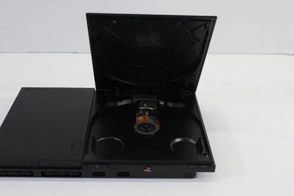 Sony PlayStation 2 Slim Console System (SCPH-90000) at Gamers INC, featuring a compact design with built-in AC adapter and PS1 backwards compatibility for playing your entire library of classic PlayStation and PS2 games with a 3rd party controller inside disc tray