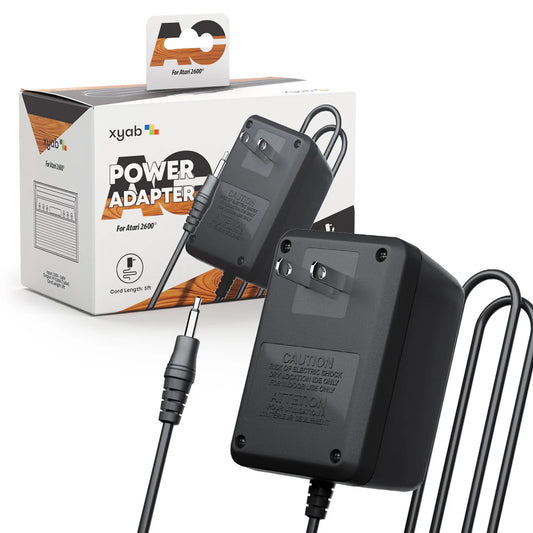 Atari 2600 power supply adapter with label showing voltage specifications and cable