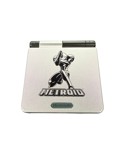 Game Boy Advance SP Metroid custom shell AGS-001 handheld gaming system featuring a custom black and gray Metroid themed shell design with a frontlit screen clamshell form factor rechargeable battery and compatibility with Game Boy Advance and Game Boy Color games clam shell top