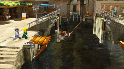 LEGO Indiana Jones The Original Adventures Platinum Family Hits Xbox 360 video game featuring action adventure gameplay based on Indiana Jones classic movie scenes LEGO characters exploration puzzle solving combat challenges collectible treasures and cooperative gameplay Xbox 360 retro video game collection collectible gaming appeal gameplay
