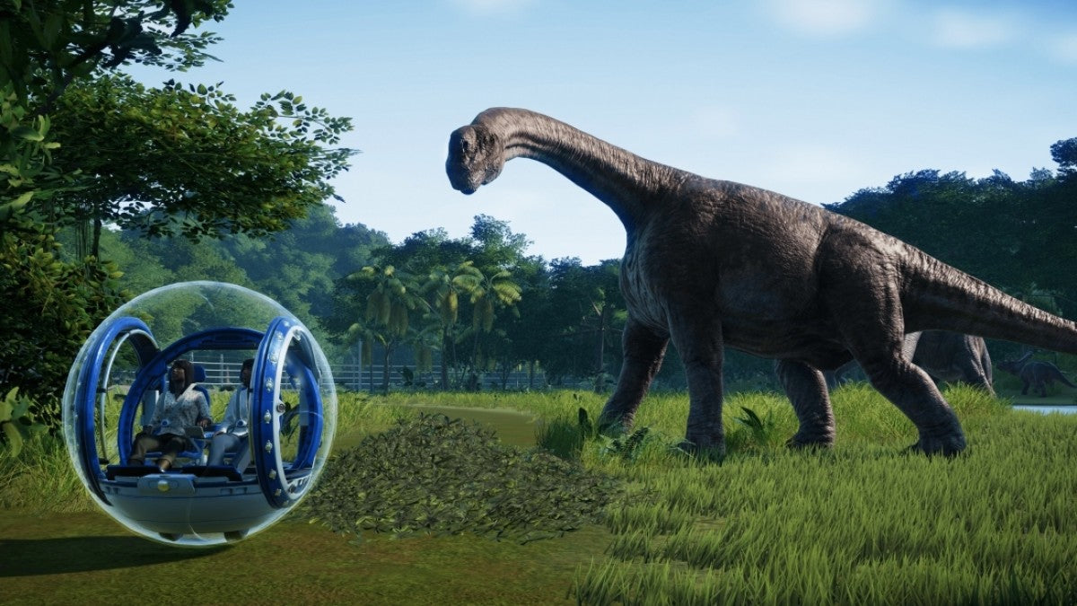 Jurassic World Evolution PlayStation 4 PS4 park management simulation video game building dinosaur theme park on five islands researching DNA creating dinosaurs from films containing herbivores carnivores enclosures guest facilities Sabertooth games gameplay 