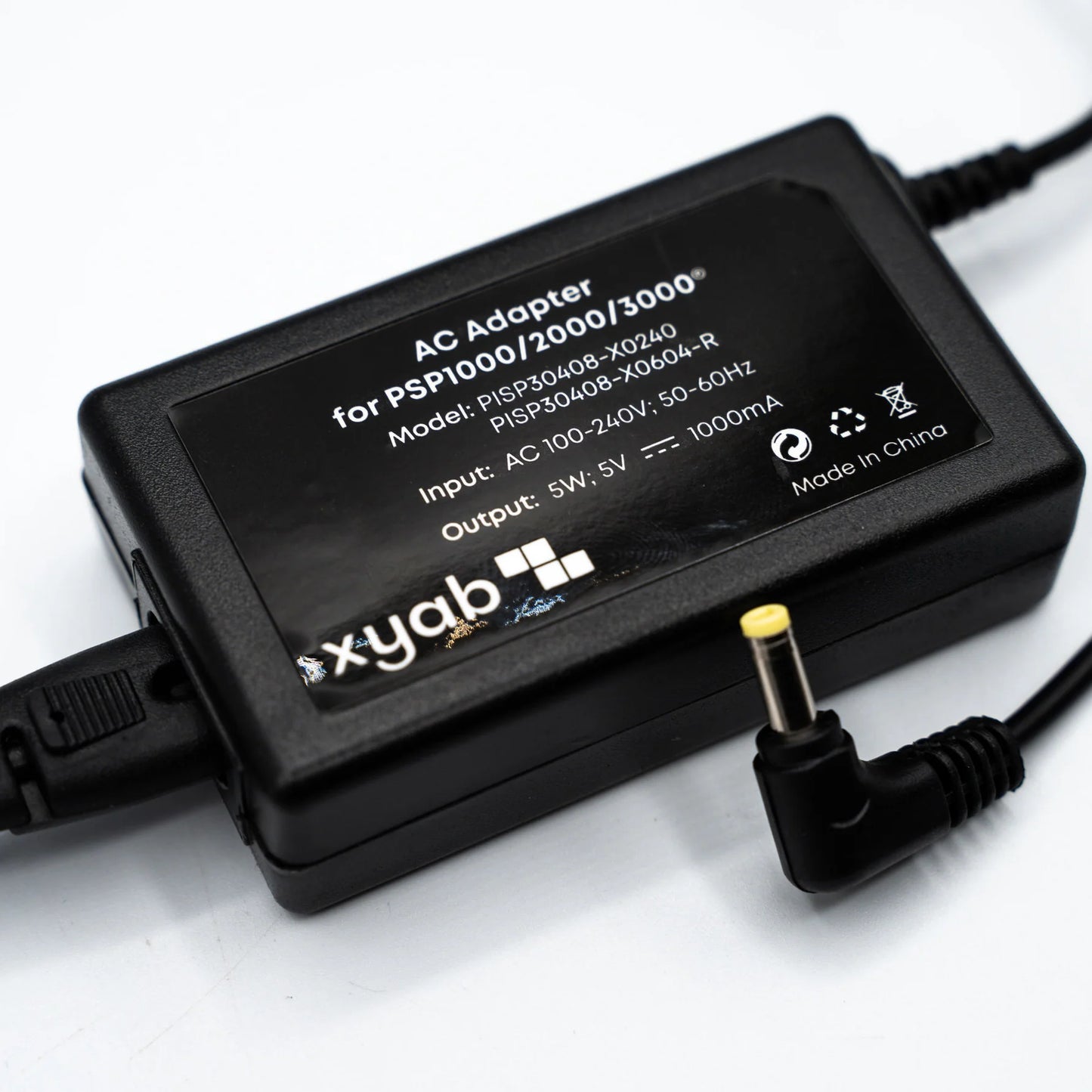 XYAB brand AC adapter and charger compatible with all PlayStation Portable (PSP) models for powering and charging handheld consoles