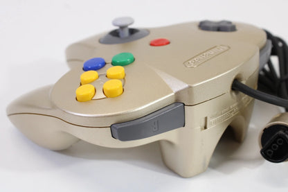 Top corner view of the gold Nintendo 64 controller, highlighting the joystick, shoulder buttons, and part of the D-pad for detailed perspective of the controller design