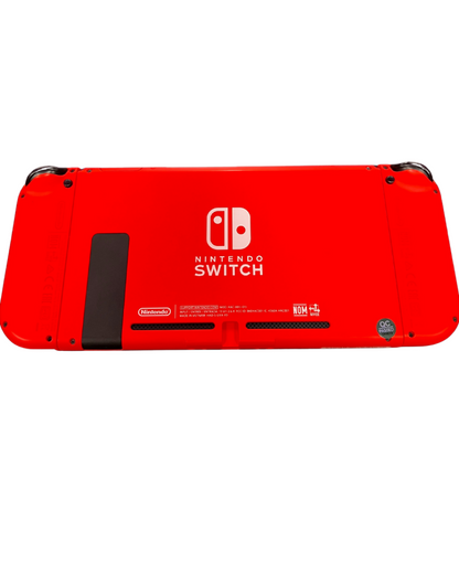 Rear view of the red Mario Edition Nintendo Switch console with matching red Joy-Con controllers attached, showing the solid red back casing and kickstand.