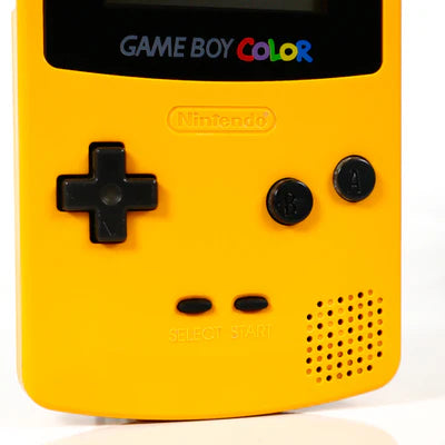 Lower half view of a yellow Nintendo Game Boy Color showing directional pad, A and B buttons, start and select buttons, and speaker grill.