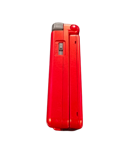Side view of the official Game Boy Advance SP Groudon Edition console closed, showing the red metallic casing and volume slider.