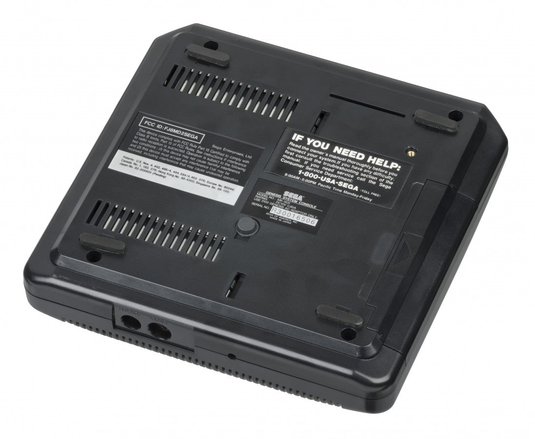 Bottom view of a Sega Genesis Model 2 console showing screw placements, ventilation grilles, and label details.