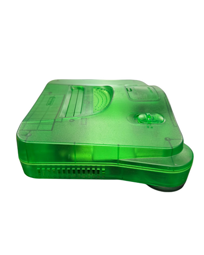 Nintendo 64 Jungle Green console featuring the translucent green clamshell design standard N64 hardware with cartridge slot, four controller ports, and compatible with classic N64 games
