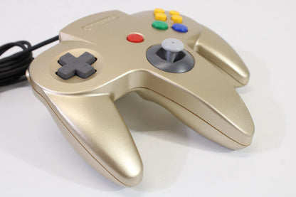 Left side view of the gold Nintendo 64 controller, showing D-pad, ergonomic grip, and side contours for comfortable gameplay