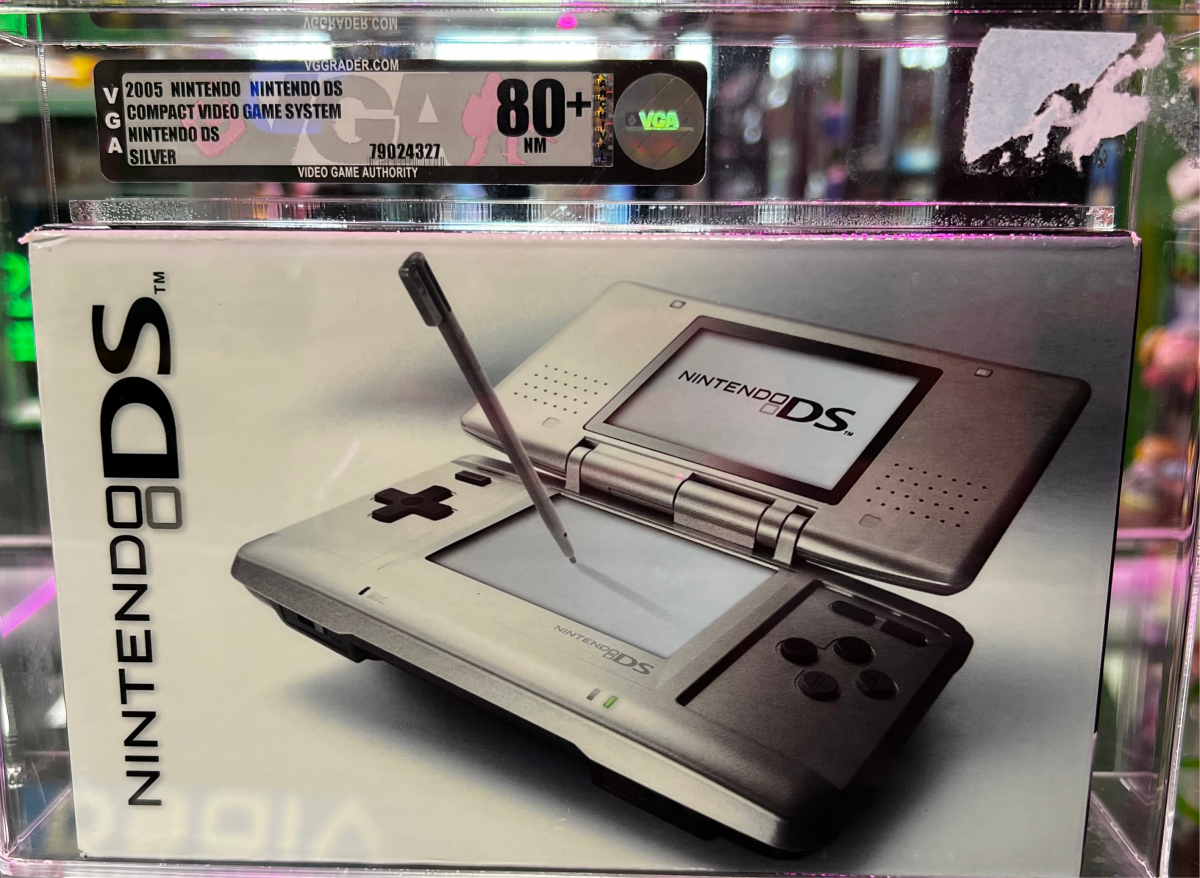Front view of a sealed, VGA-graded Nintendo DS system encased in a clear acrylic display box with visible grading label.