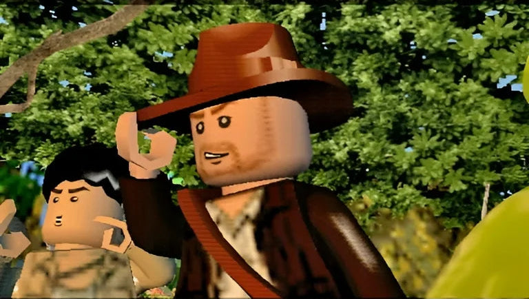 LEGO Indiana Jones The Original Adventures PlayStation Portable box art displaying the adventurous Lego minifigure and action scenes gameplay screenshot